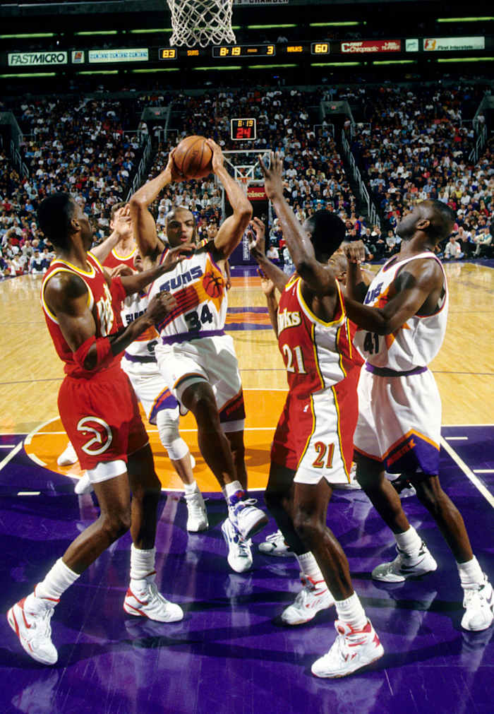 Feb 18, 1993; Phoenix, AZ, USA; FILE PHOTO; Phoenix Suns forward Charles Barkley (34) battles for a rebound between Atlanta Hawks forward Dominigue Wilkins (21) and Kevin Willis (42) at America West Arena.